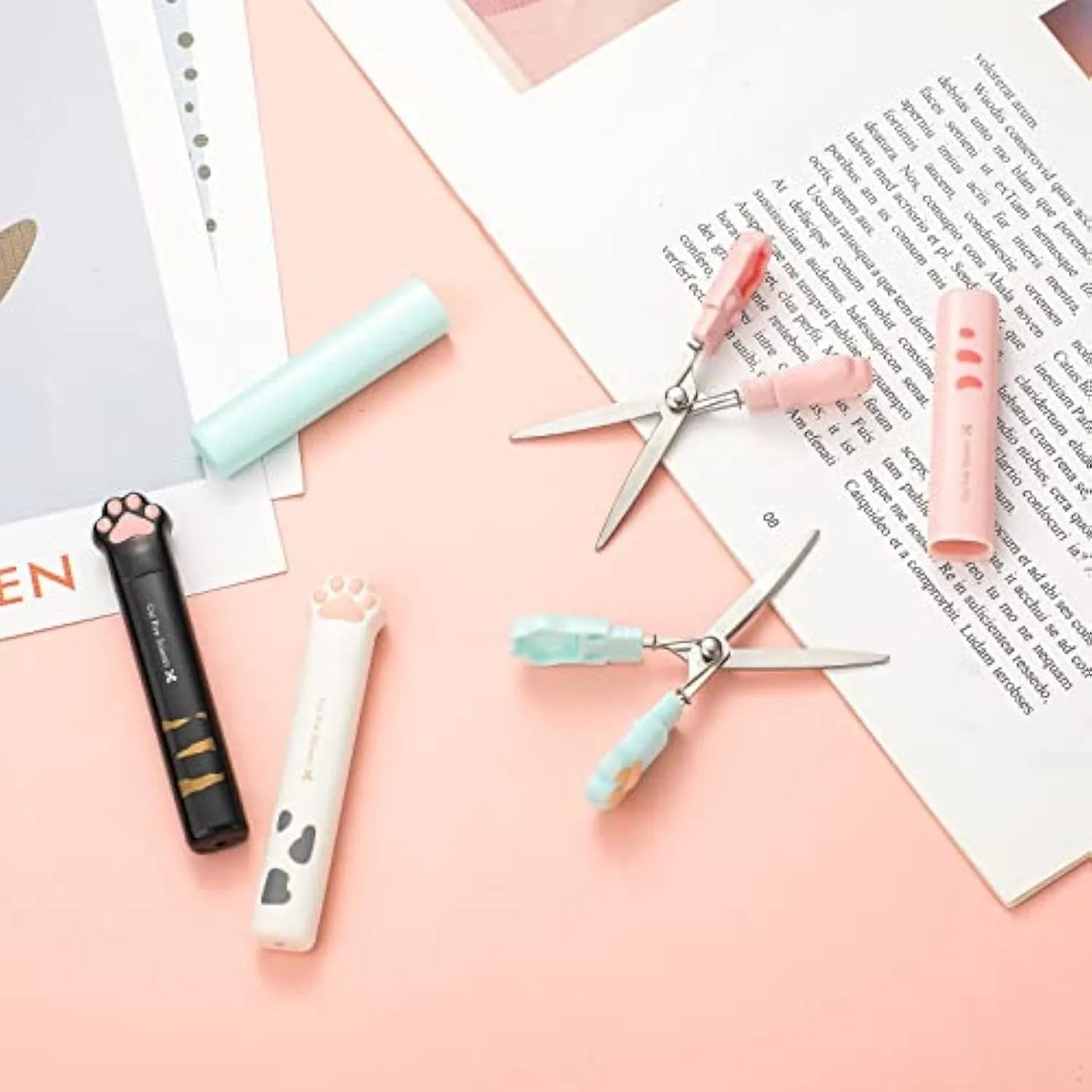 Closed and open views of cute cat paw design mini folding safety scissors on a craft background.