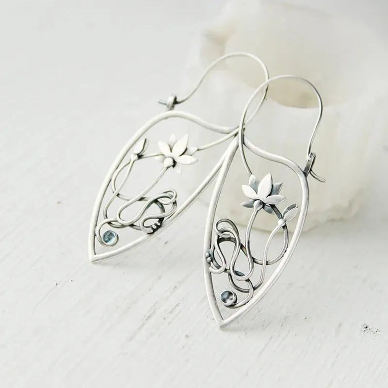 Silver lotus flower vine earrings with geometric rhinestone accents and retro styling