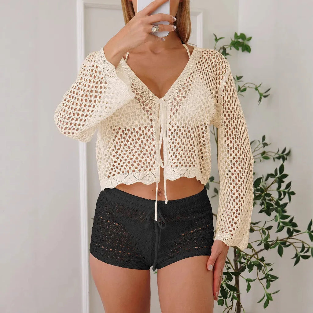 Short apricot coloured women's cardigan blouse with hollow weave texture and flared bell sleeves.