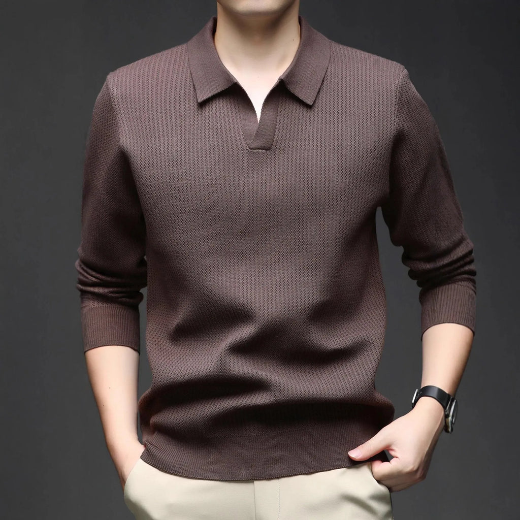 Man wearing a loose-fit green pullover sweater, a casual autumn garment.
