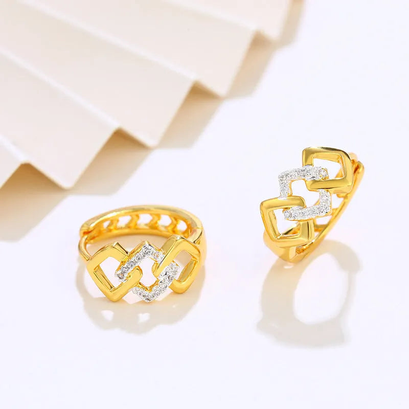 Gold geometric hollow out alloy earrings with ear clip fastening shown from front angle