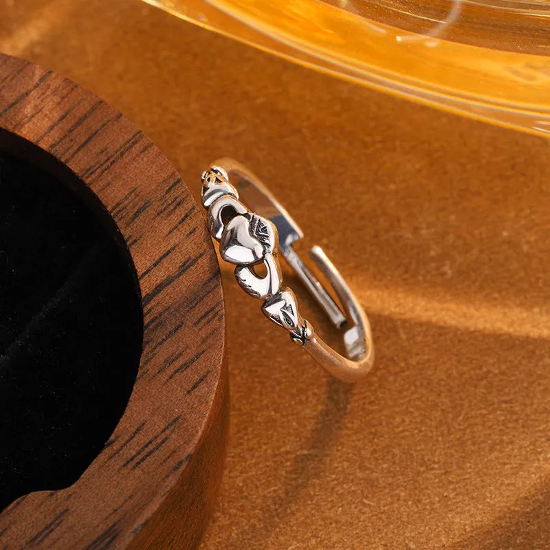 Retro silver heart open ring on finger showing adjustable copper construction and heart silhouette