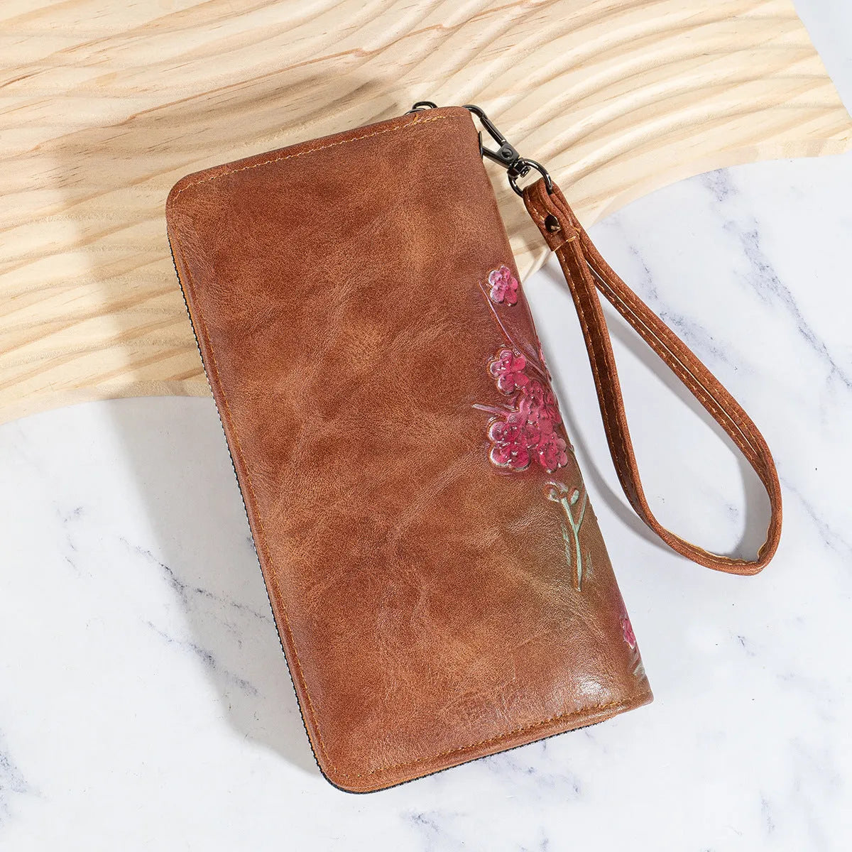 Embossed floral handbag with retro styling and zipper closure