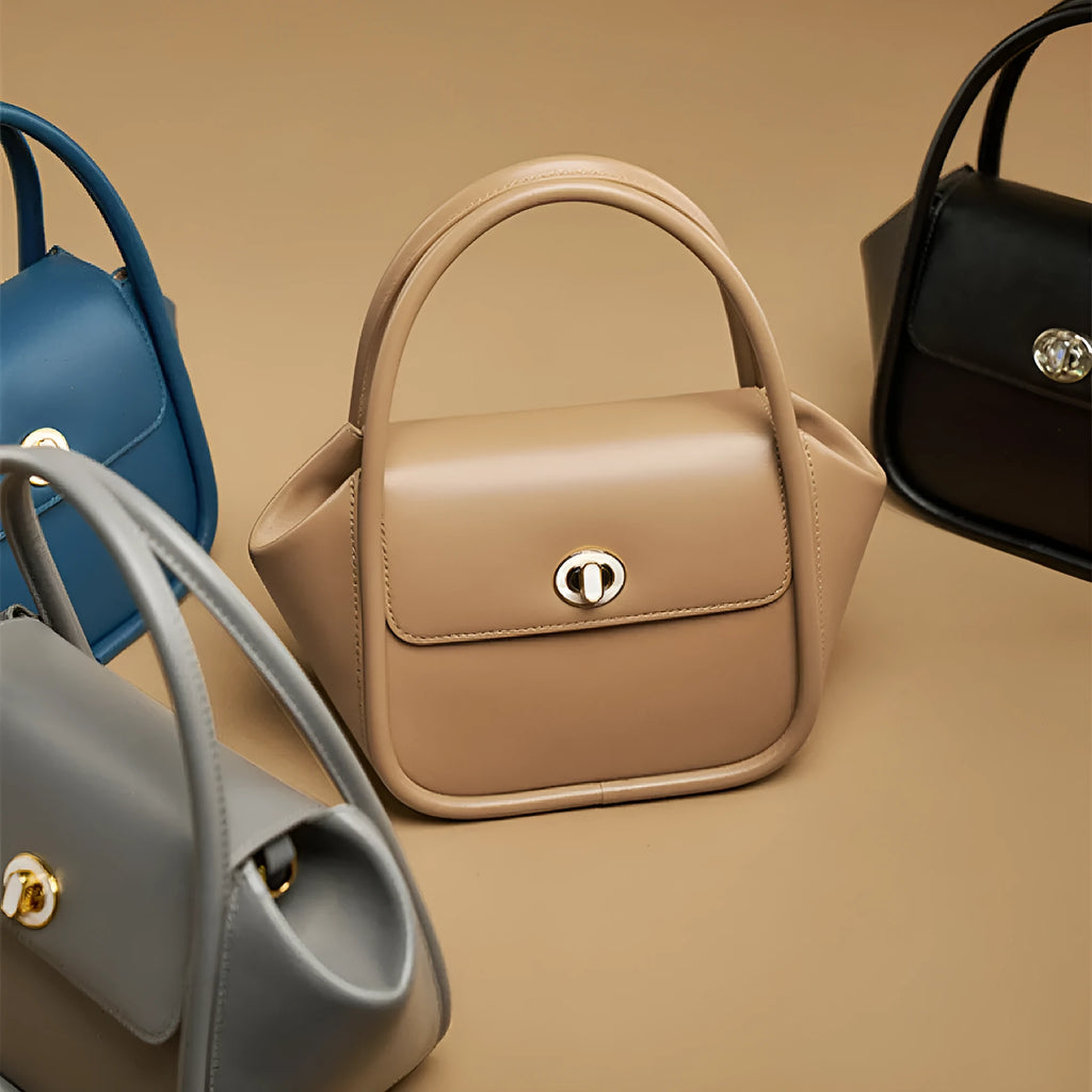 A wing-shaped cow leather women's tote bag with a cross-body strap and latch closure in a choice of colours.