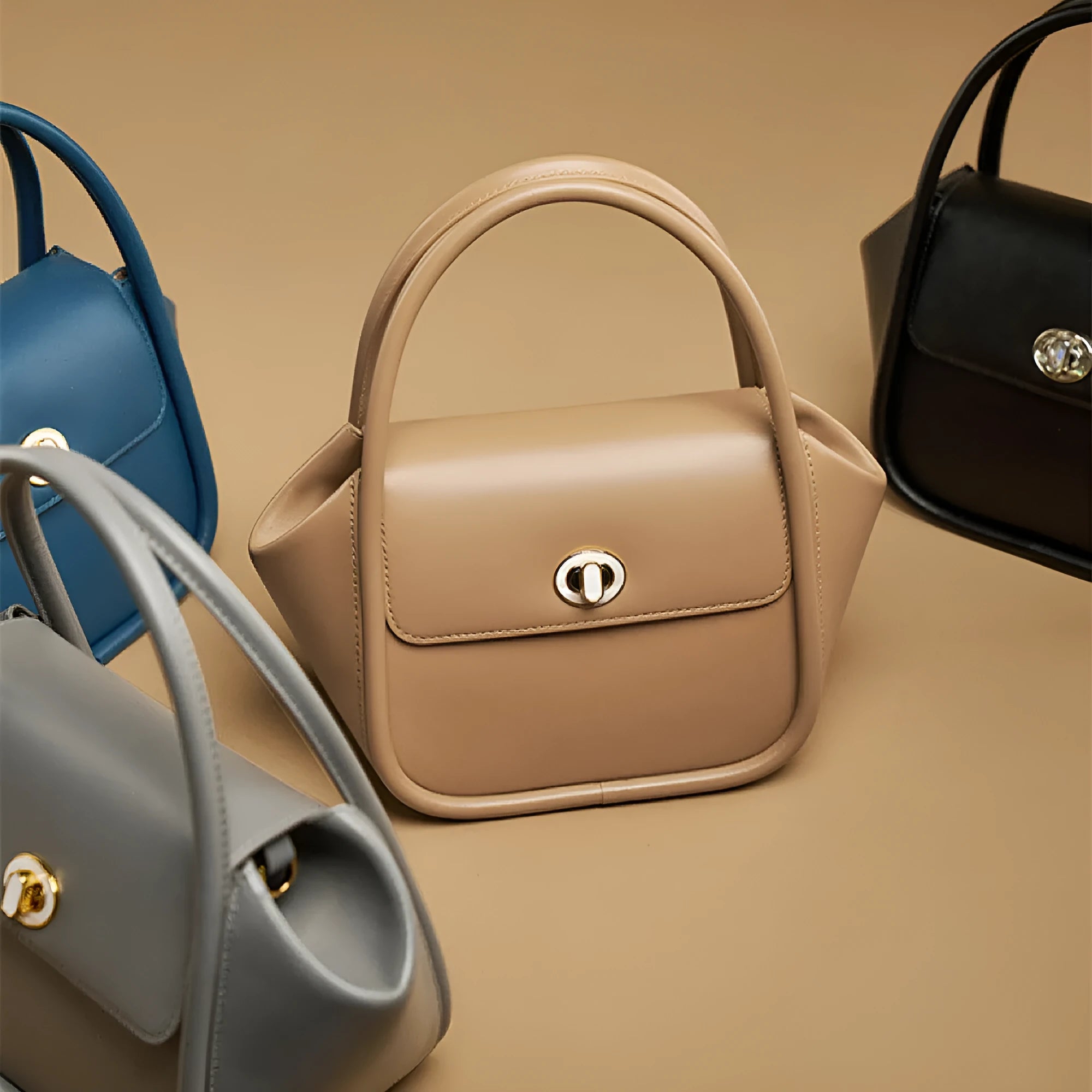 A wing-shaped cow leather women's tote bag with a cross-body strap and latch closure in a choice of colours.