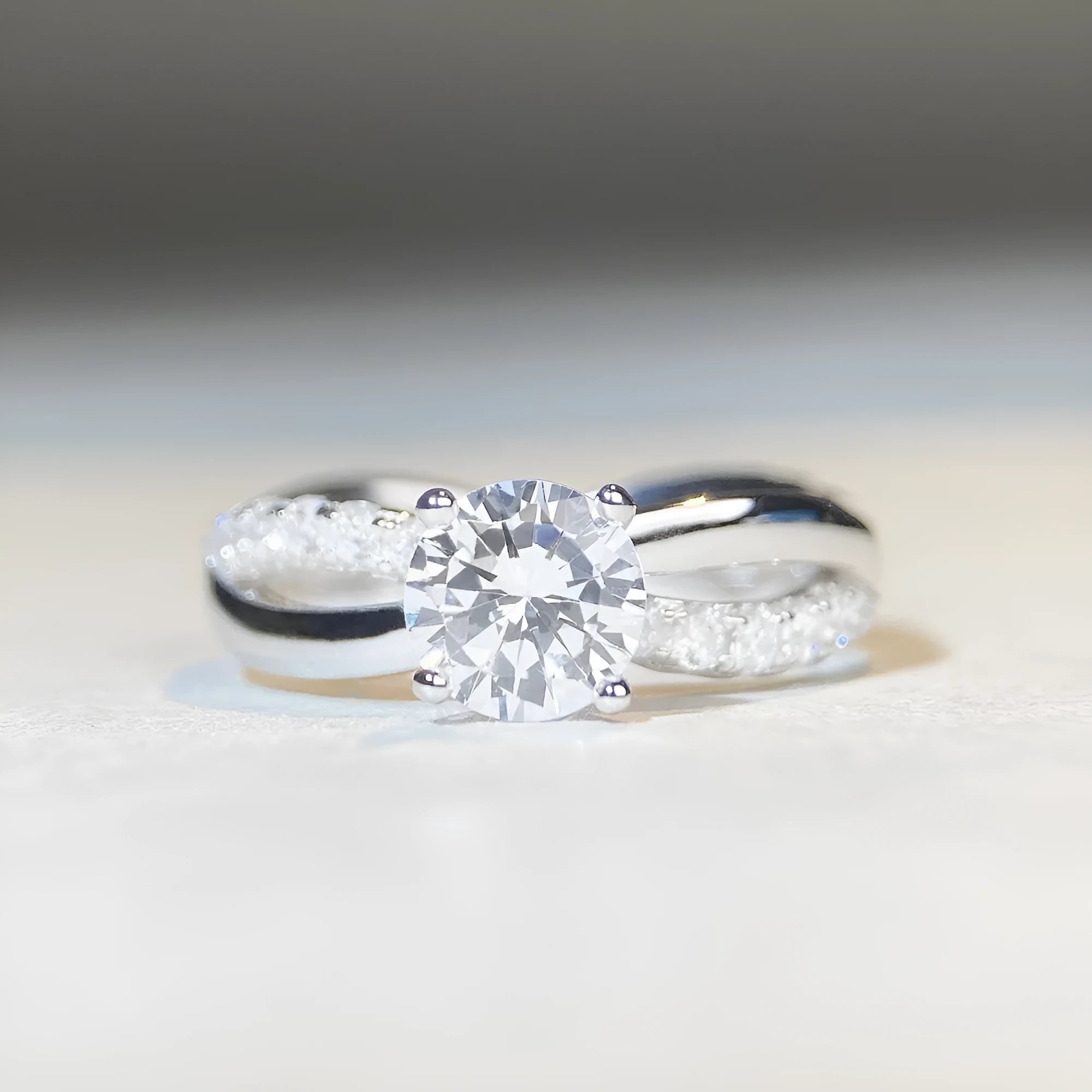 Geometric twisted silver band ring with 1 karat moissanite stone in four-claw setting, side view showing cross details