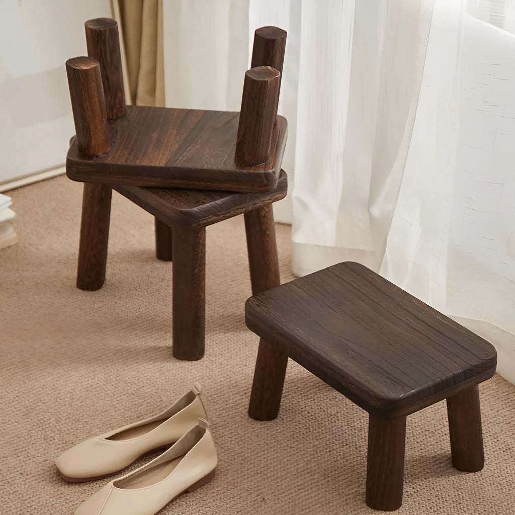 Solid wood household changing stool with distressed finish and bracket structure legs.
