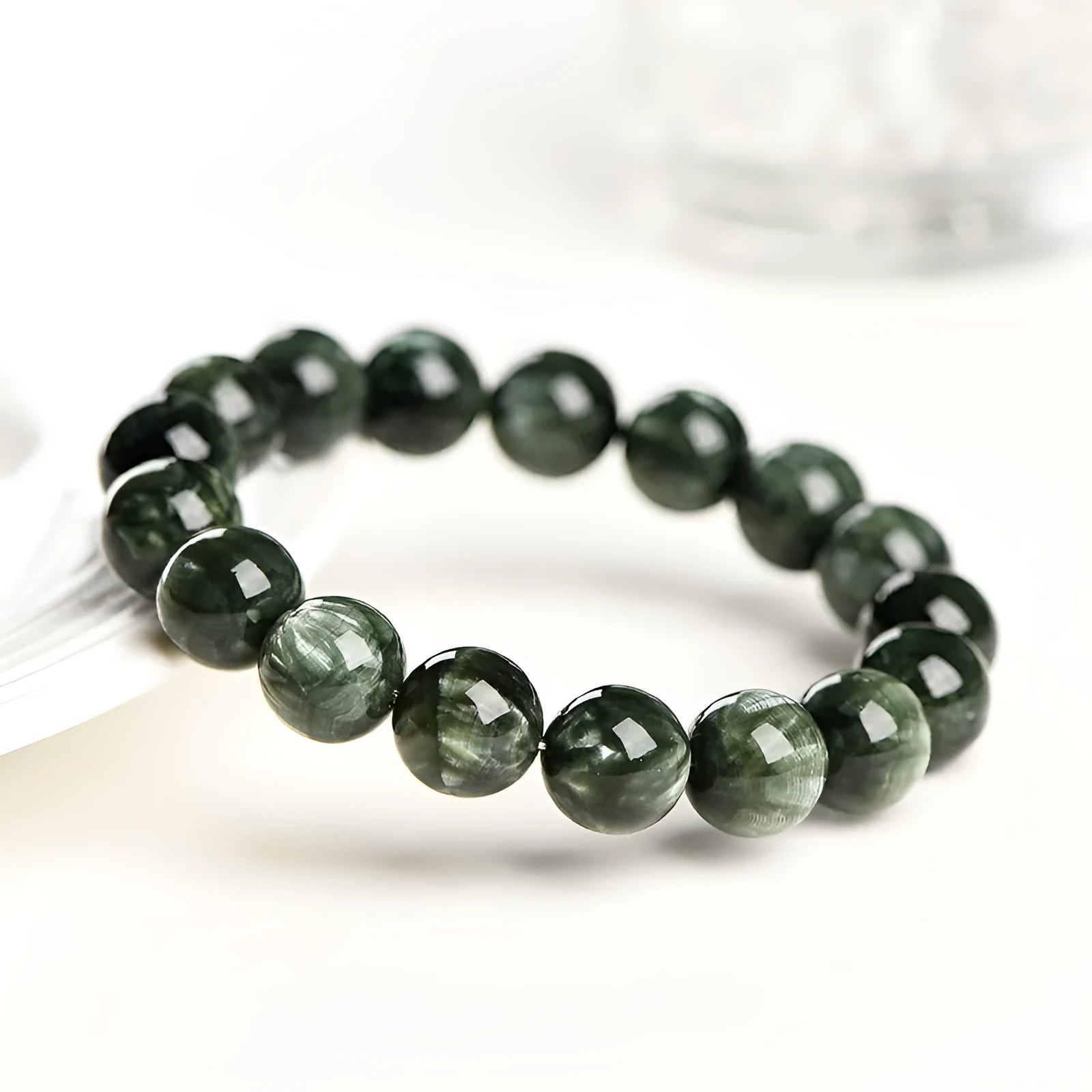 Green Dragon Crystal bracelet with 8-9mm round beads and a Ruyi element.