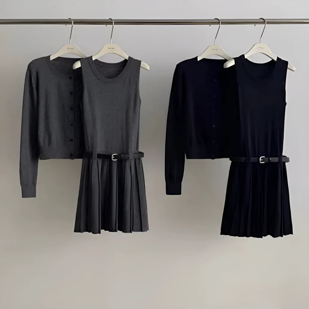 Women's grey art retro knitted vest skirt and long sleeve cardigan two-piece set on a hanger.