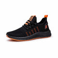 Men's black casual sneakers with flying weave upper, cross straps, and a low flat profile on a white background.