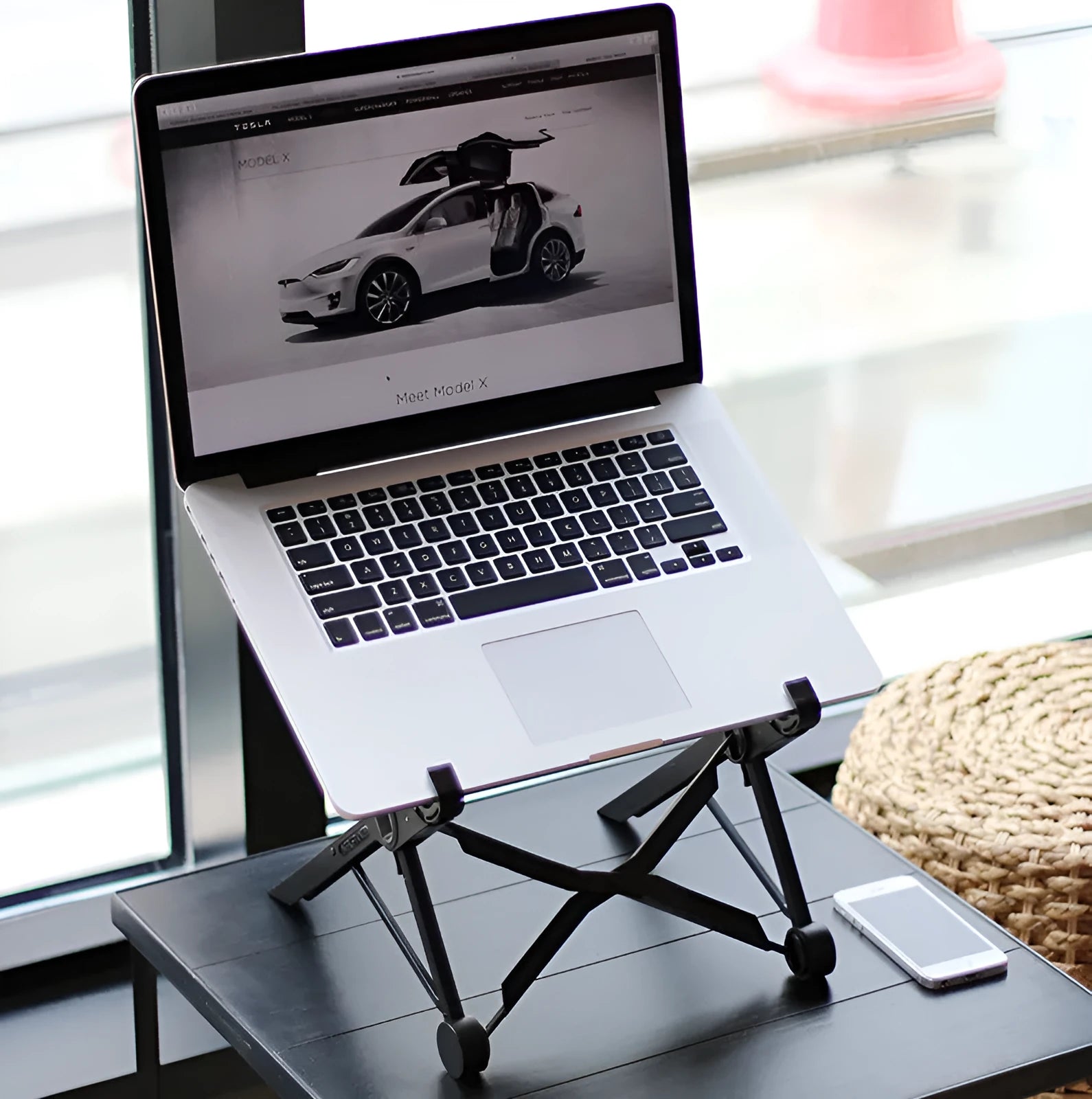 Black folding laptop stand with aluminium frame and reinforced nylon platform in extended position