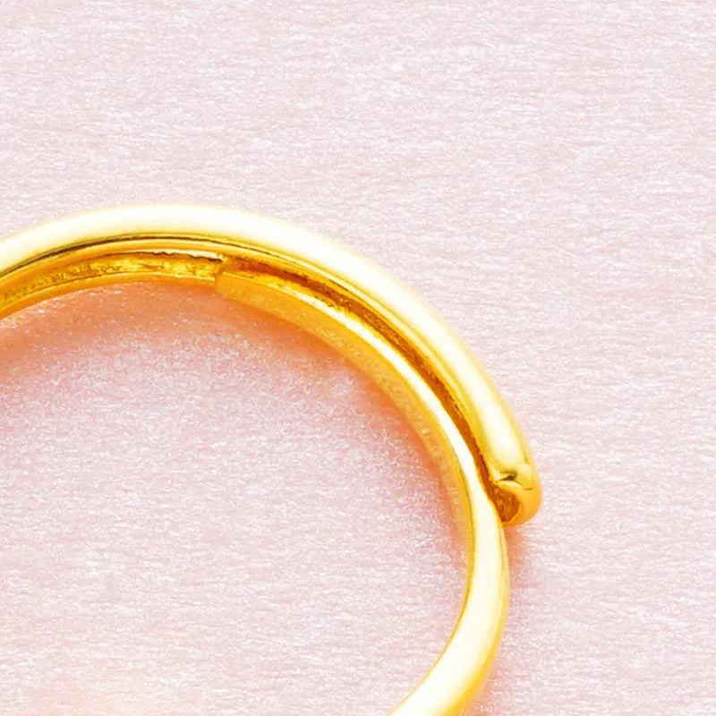 Adjustable copper ring with placer gold zircon accents shown in six colour options