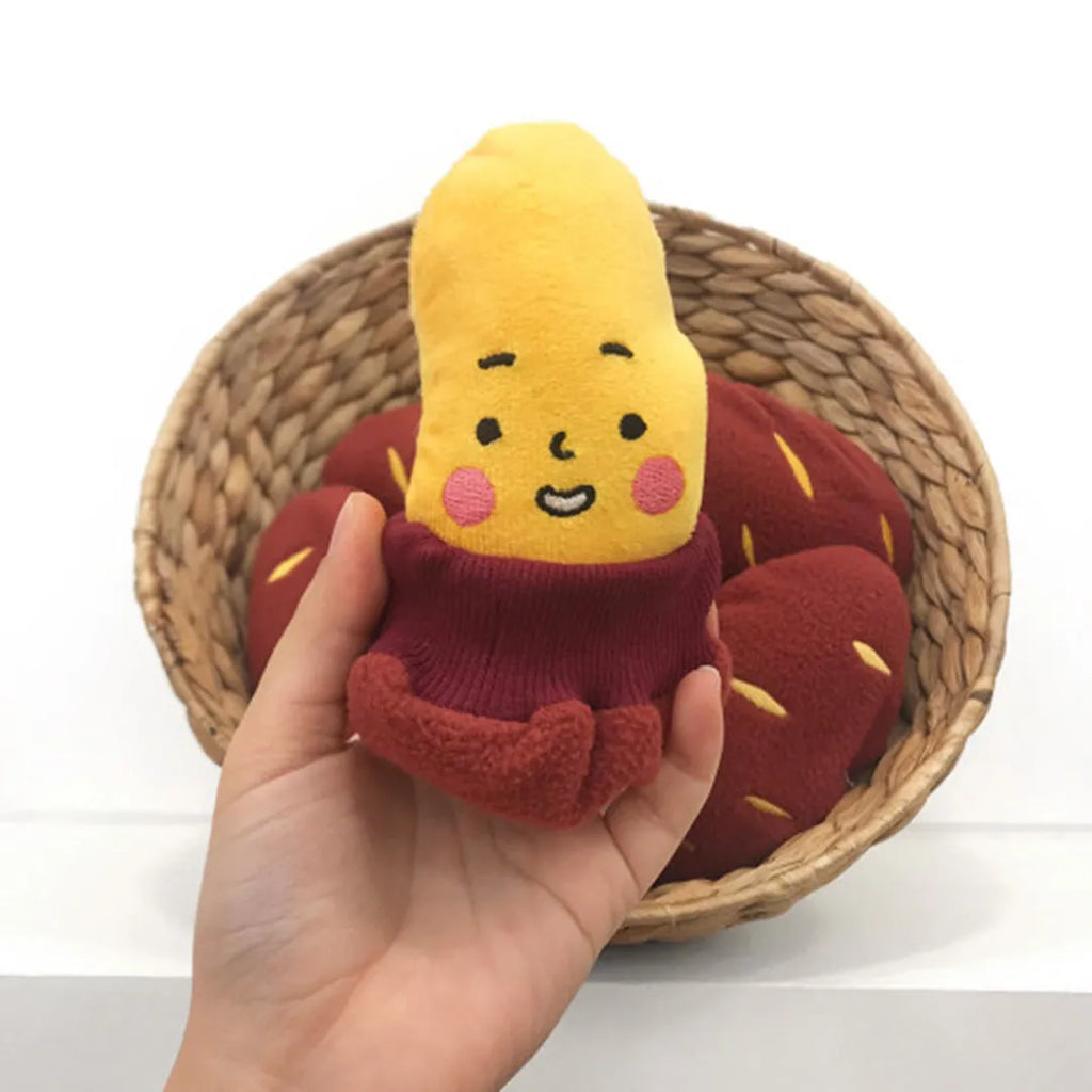 Red fabric pet toy shaped like sweet potato with internal hidden treat pockets for dogs