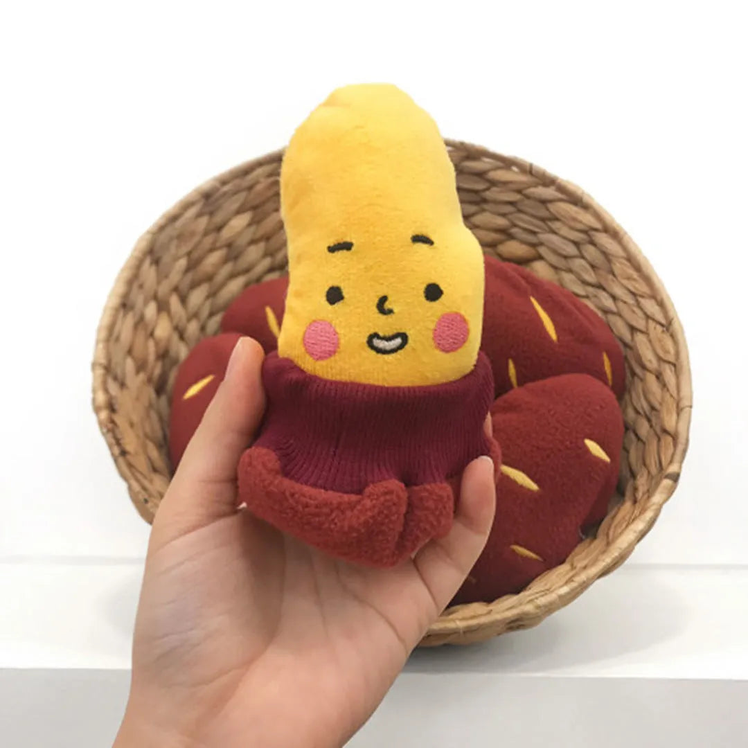 Red fabric pet toy shaped like sweet potato with internal hidden treat pockets for dogs