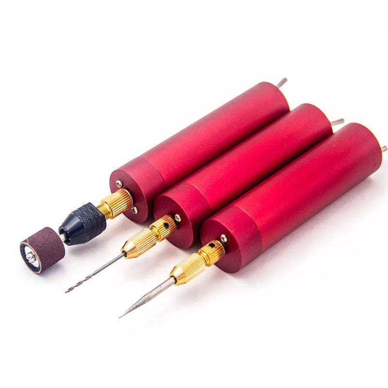 USB-powered aluminium alloy mini electric drill grinder with three drill bits and a wrench on a workbench.