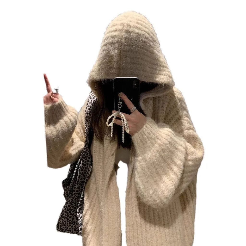 A woman wearing a brown retro-style hooded cardigan with thick knit fabric.