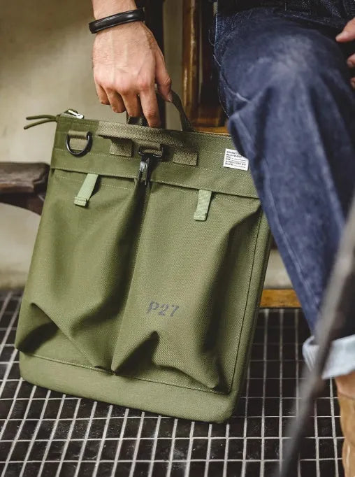 Marden canvas crossbody messenger bag in military green showing laptop compartment and shoulder strap