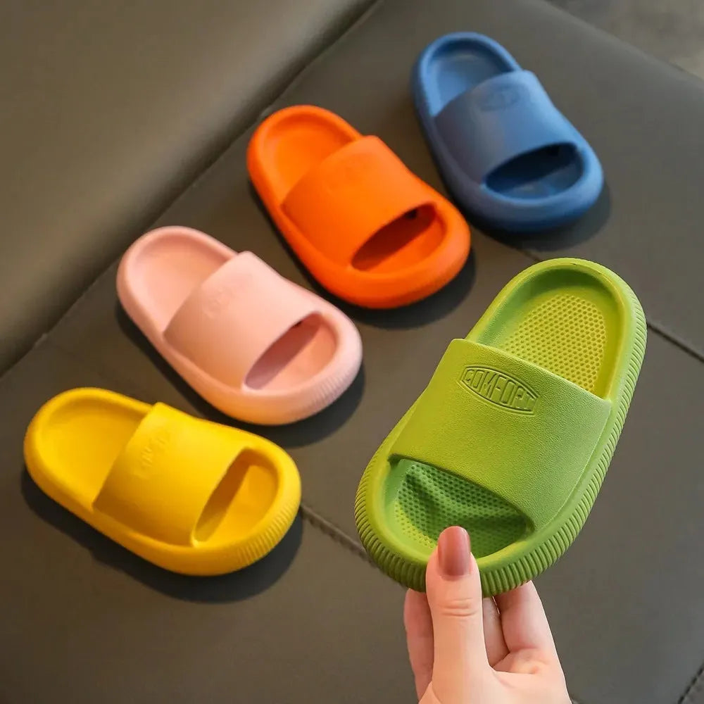 Children's colourful EVA slippers with a textured non-slip sole, shown in blue, green, orange, pink, and yellow.