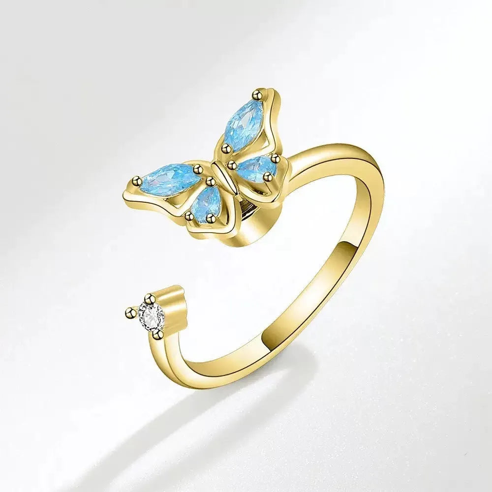 Butterfly adjustable ring with electroplated white gold finish and blue diamond accent on copper base