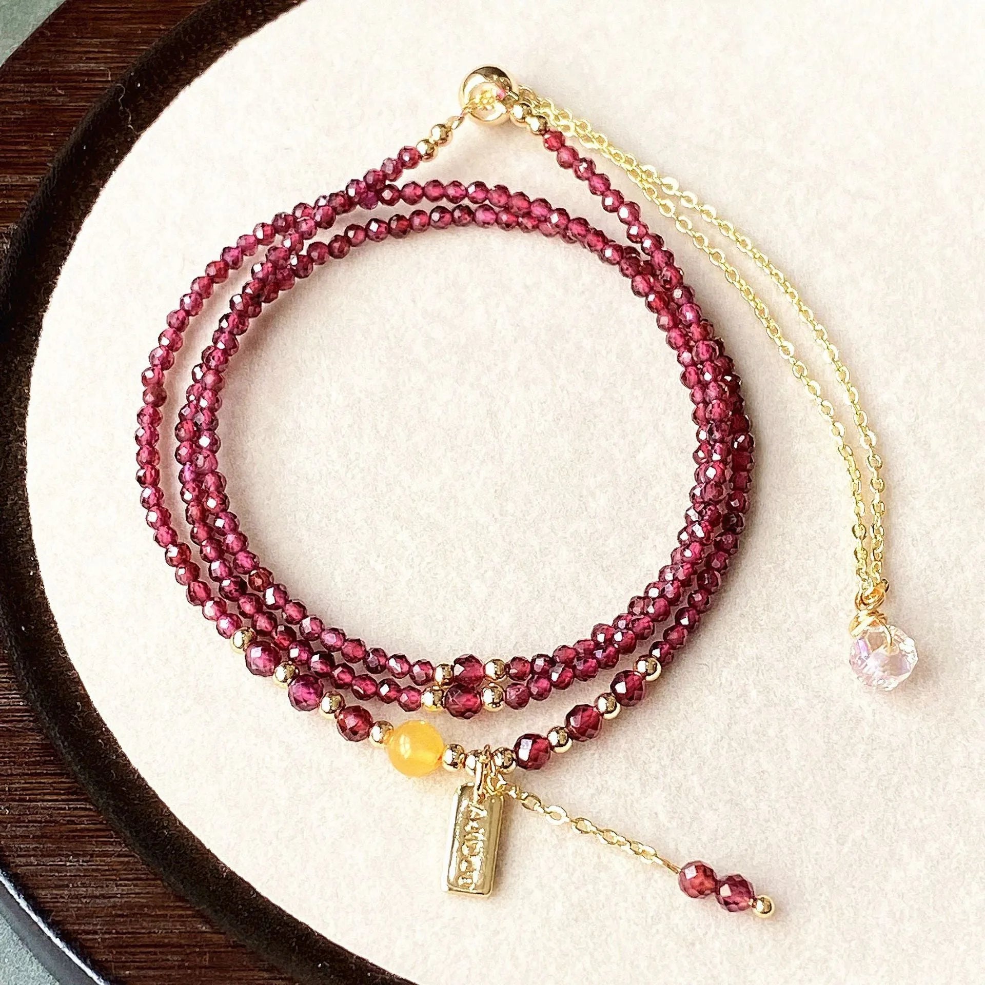 Wine red garnet bracelet with three circle design showing 2.5mm cut stone beads and electroplated metal