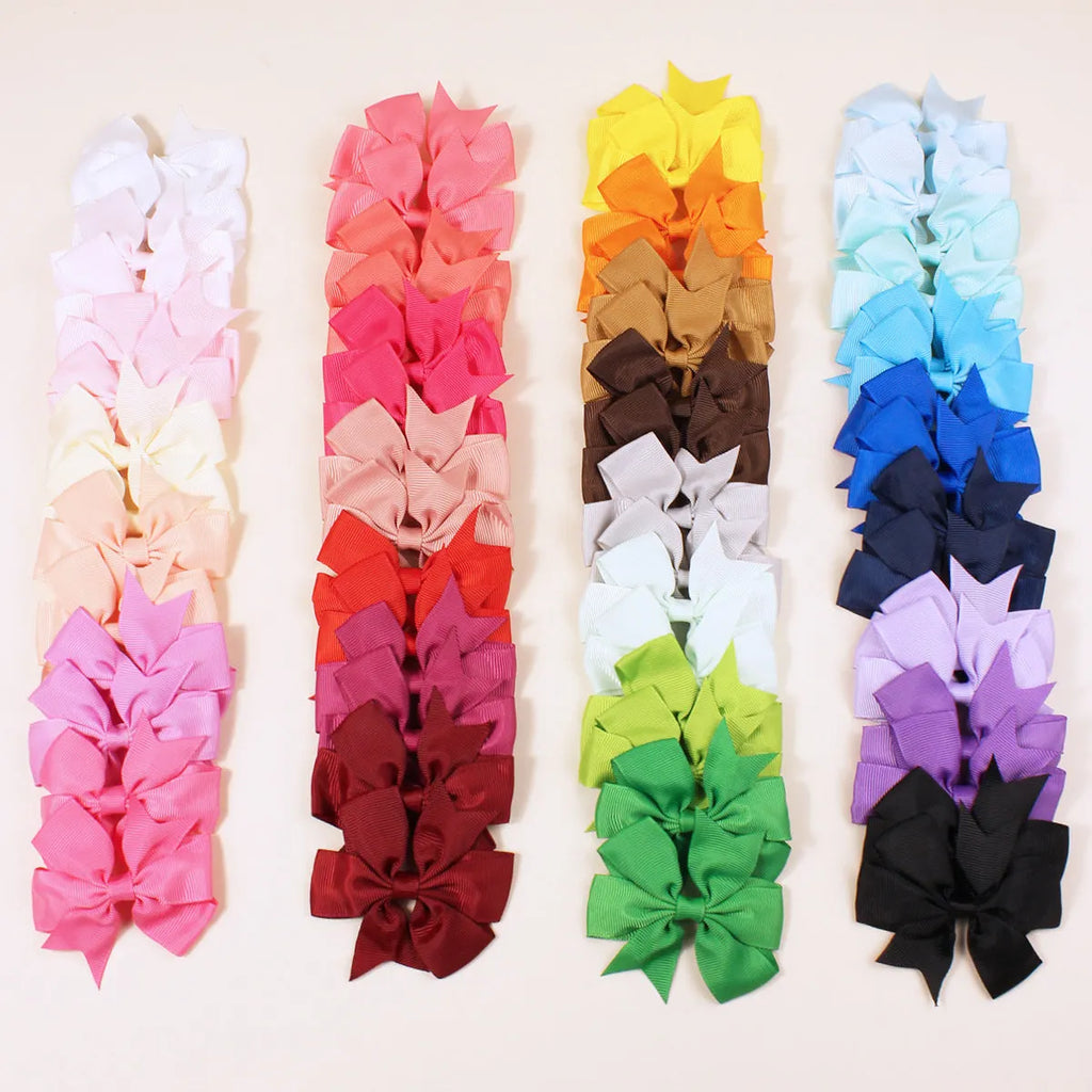20 pairs of multicoloured 3-inch grosgrain ribbon pinwheel hair bows with alligator clips for baby girls.