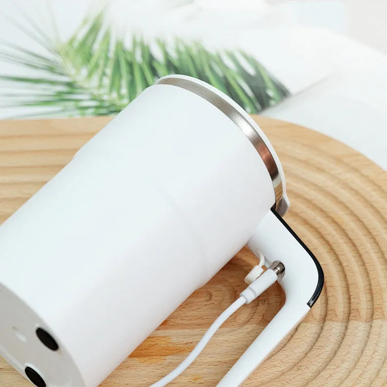 White electric coffee mug with LCD display showing temperature and magnetic stirring base