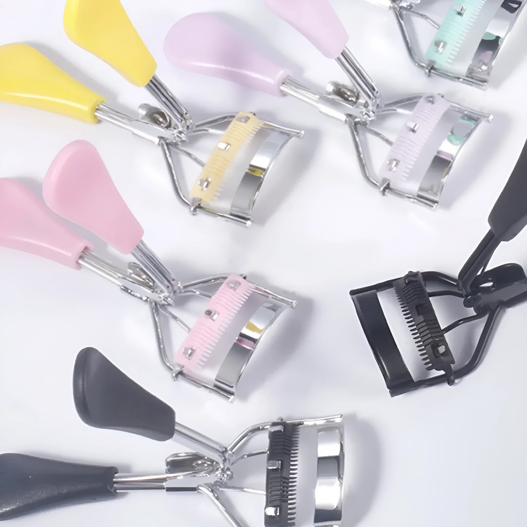 A4 manual eyelash curler with comb in assorted colours including pink and black