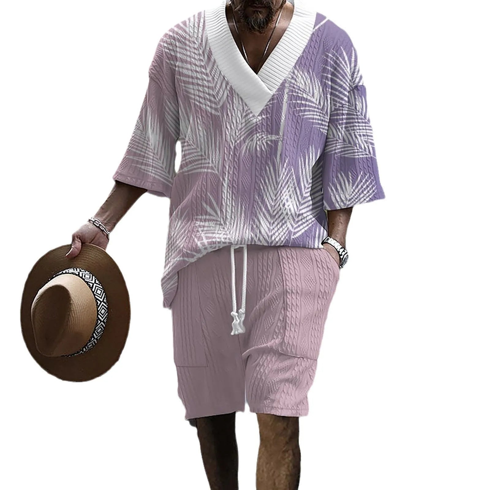 A man wearing a printed drop-shoulder knitted top and matching shorts from a casual two-piece loungewear set.