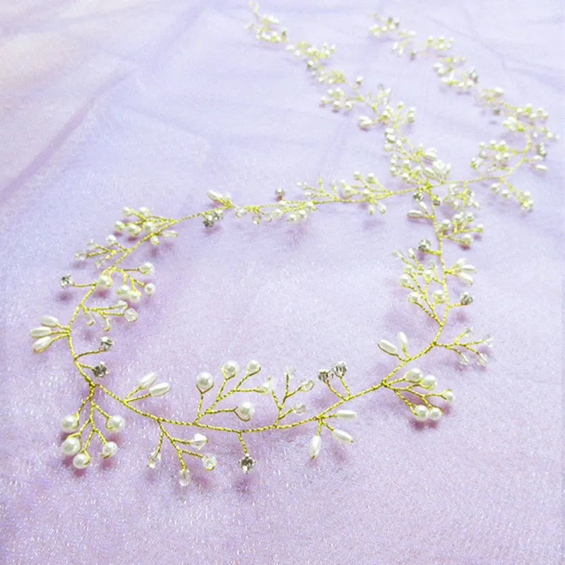 Handmade silver crystal and pearl long hair band for bridal hairstyles on a mannequin head.