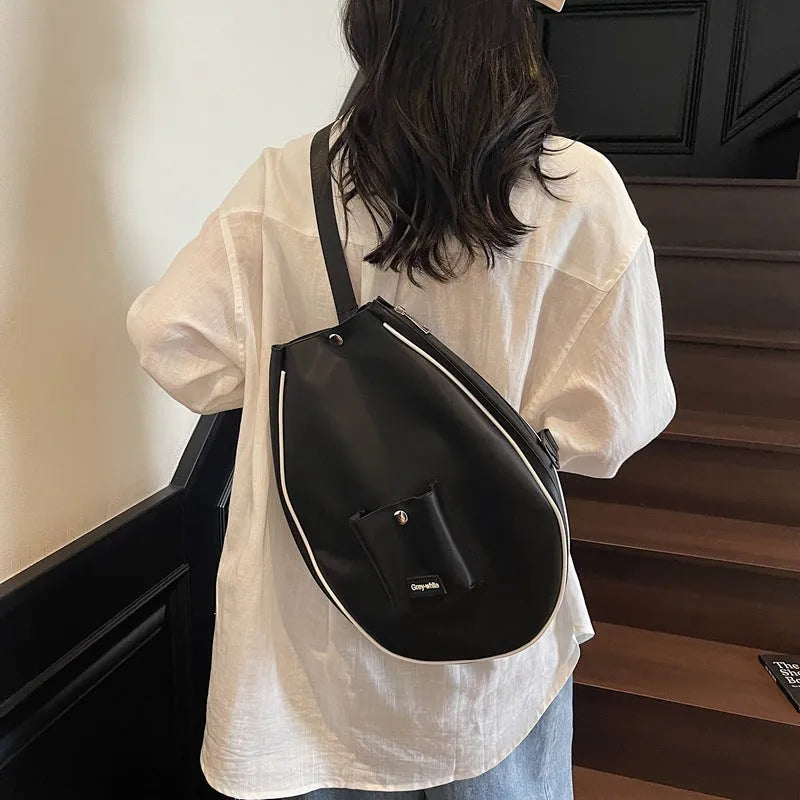 Large black yoga storage bag with one-shoulder strap showing generous capacity for workout gear
