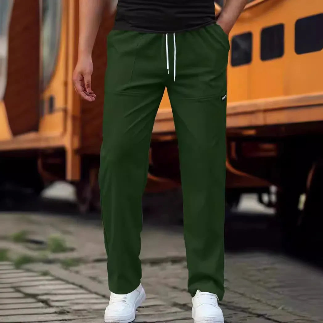 Men's light grey polyester trousers for spring and autumn wear, laid flat.