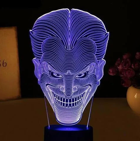USB-powered 3D acrylic LED table lamp with remote control on a desk, displaying colourful gradient lighting.