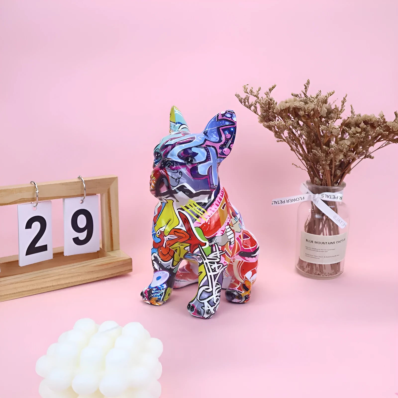 Modern graffiti-colour French Bulldog resin statue on a shelf