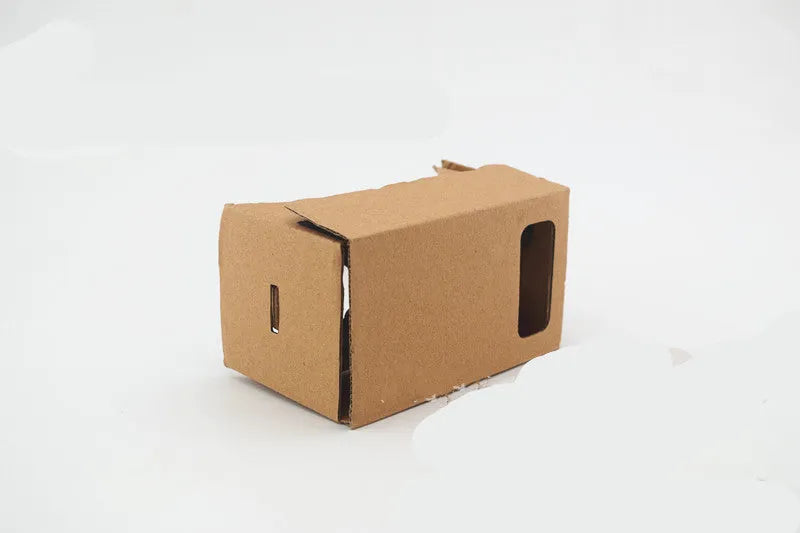 Pink and white cardboard VR glasses for smartphones with 3D lenses and a rubber strap.