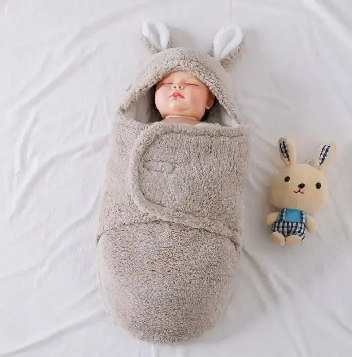 Adjustable baby sleeping bag swaddle blanket showing velcro wings and leg positioner in blue colour
