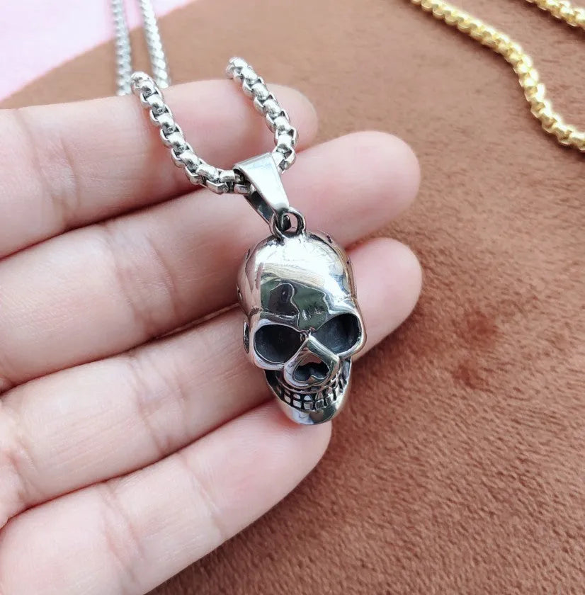 Halloween skull necklace in alloy and stainless steel with gold colour option on a black background