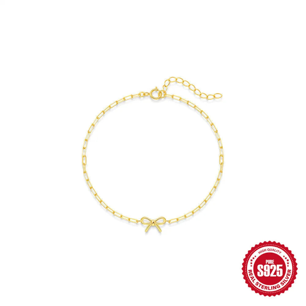 Gold tone S925 sterling silver bracelet with glossy heart charm and clip chain fastening