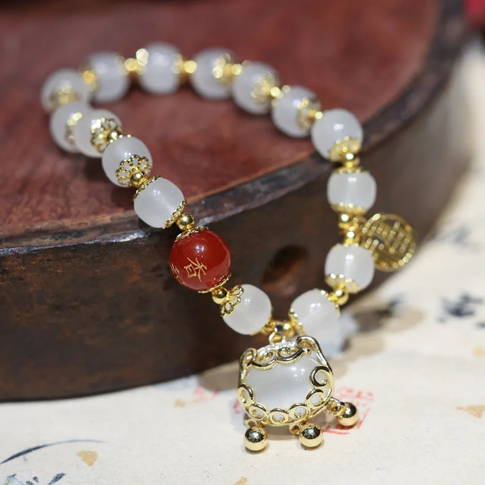Chinese style women's coloured glass bracelet with safety lock and windmill charms
