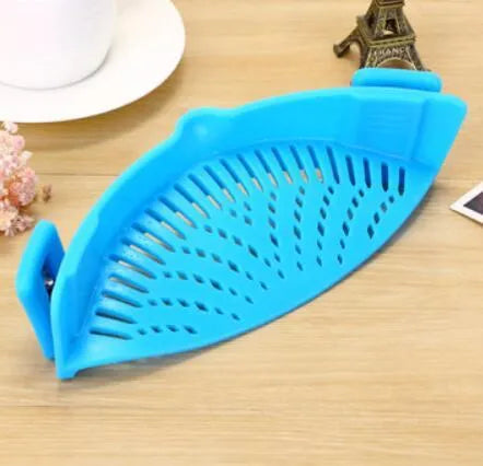 Silicone clip-on kitchen strainer with stainless steel frame attached to pot rim for draining liquids