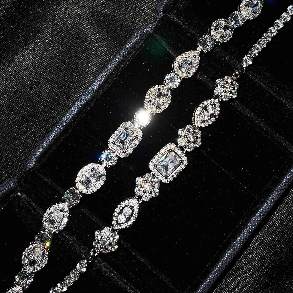 Women's silver-toned geometry bracelet with inlaid clear stones on a model's wrist.