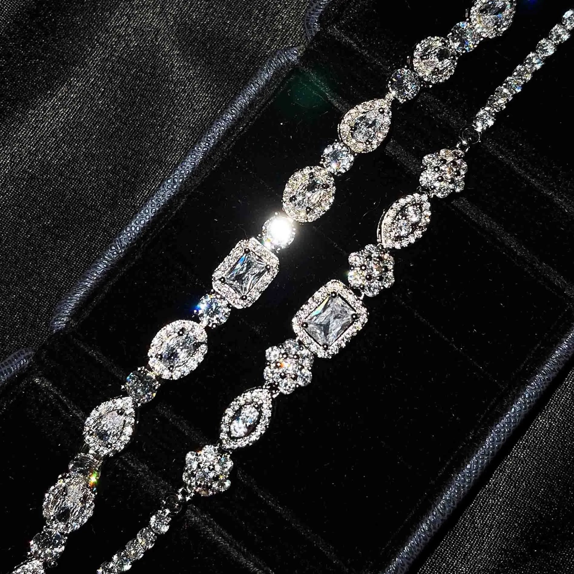 Women's silver-toned geometry bracelet with inlaid clear stones on a model's wrist.