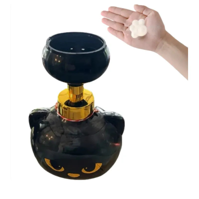 Black cartoon cat shaped plastic foam soap dispenser on a counter.