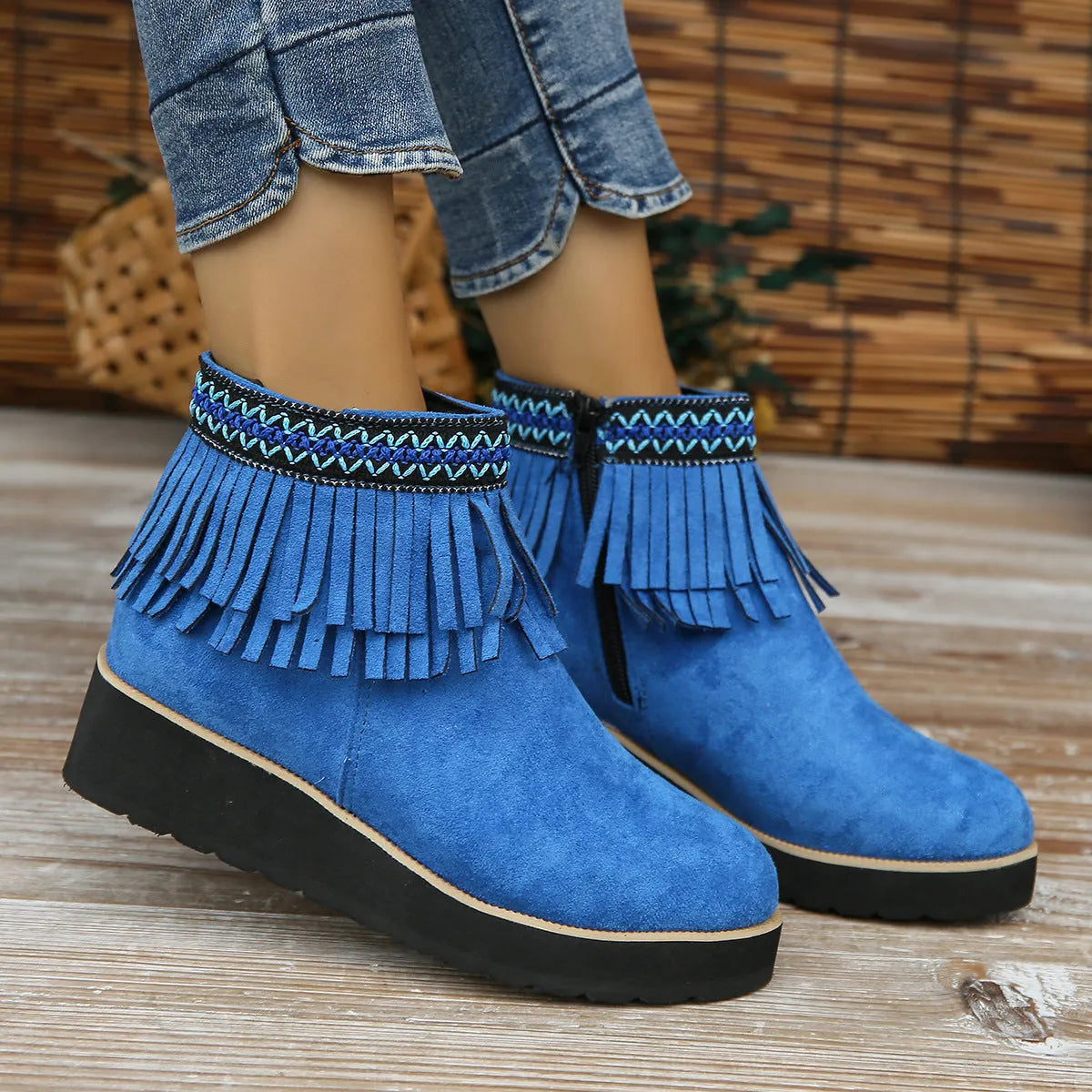 Women's dark brown suede wedge ankle boots with side zip and tassel detail on a thick rubber sole.