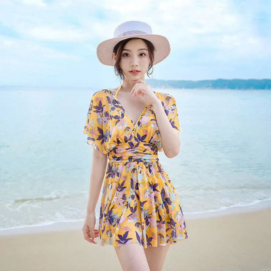 Yellow floral print women's one-piece swimsuit showing front design and polyester fabric construction