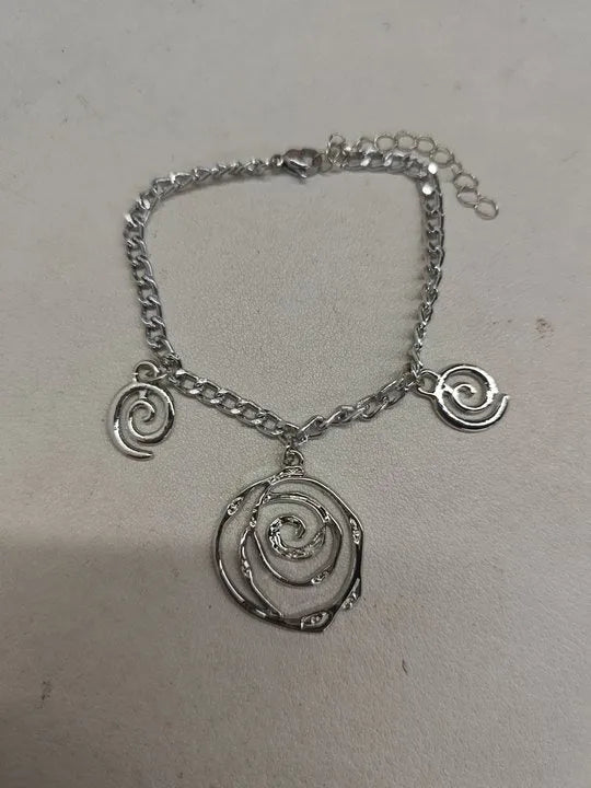 Spiral donut jewellery set showing necklace, bracelet, and earrings in geometric circle design with gold finish