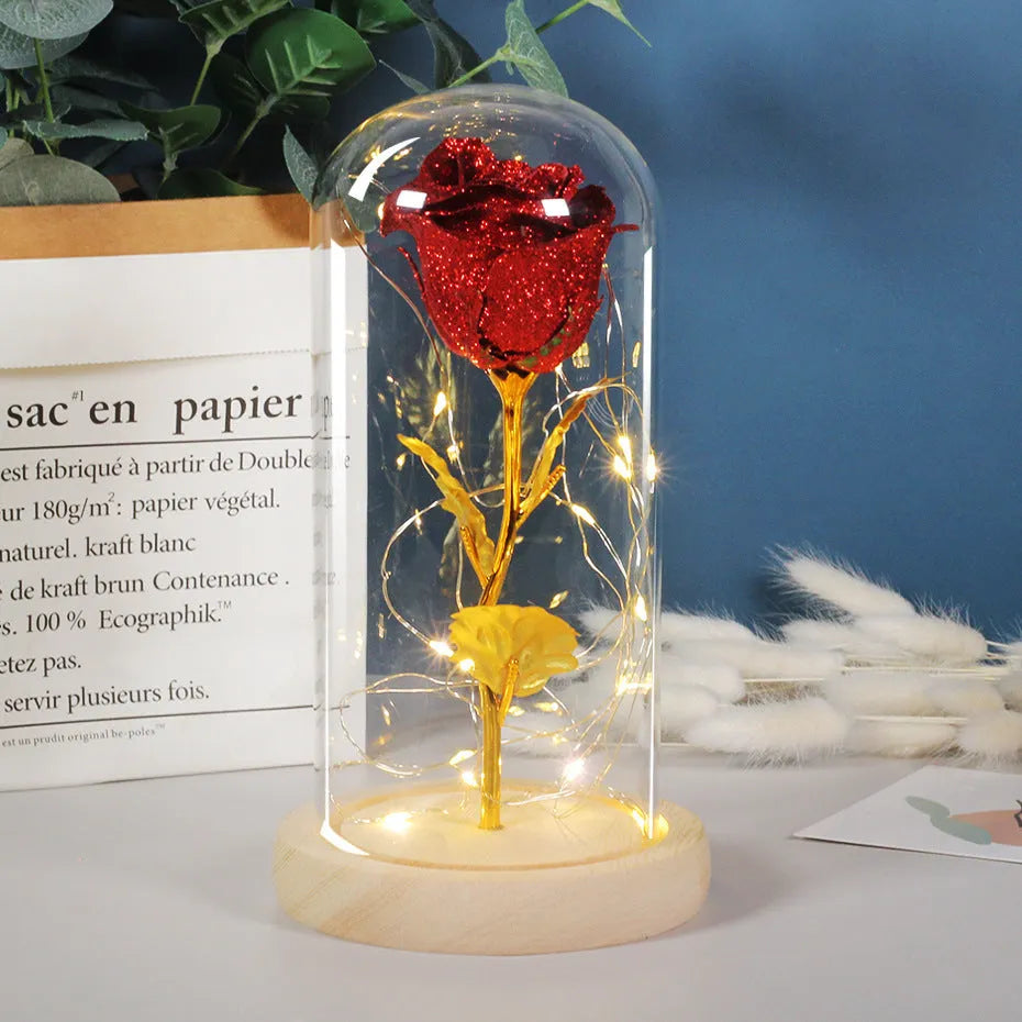 Red eternal rose in glass dome with warm white LED light string on bendable copper wire