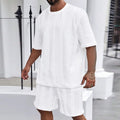 Knitted short sleeve pullover and matching shorts set in a solid colour with jacquard pattern.