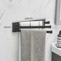 Nordic style black folding towel rack mounted on a bathroom wall