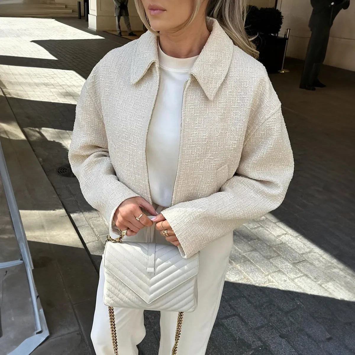 Women's apricot solid colour polyester long sleeve jacket, front view, on hanger