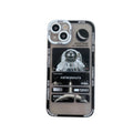 Blue-black silicone iPhone case with a graffiti-style space astronaut print, shown on an iPhone.